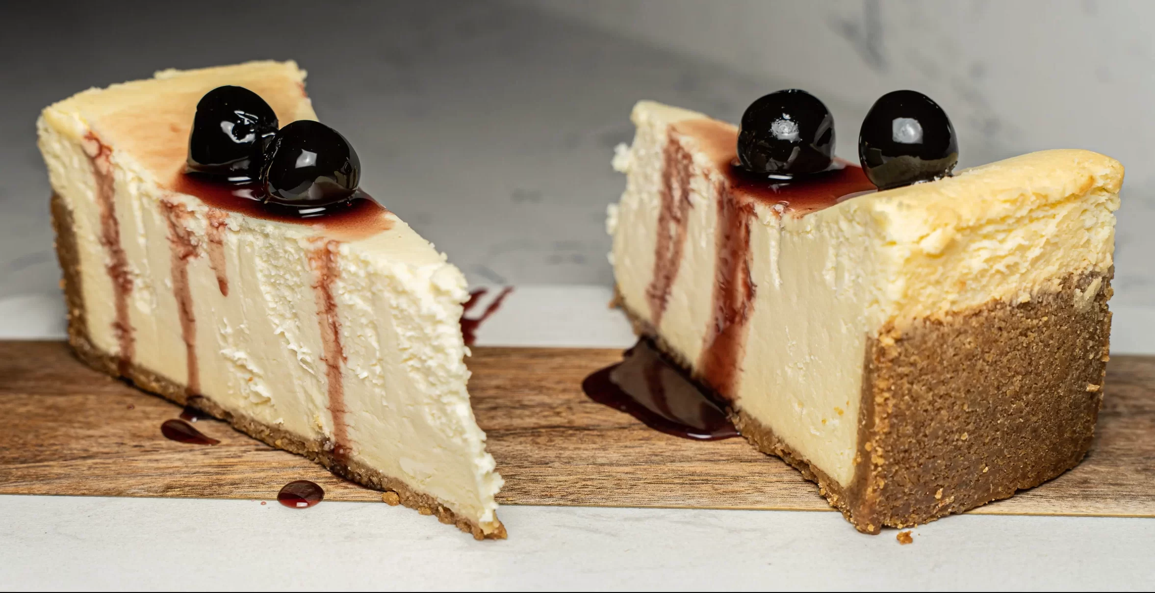 2 SLICES NY STYLE CHEESECAKE TOPPED WITH LUXARDO CHERRIES